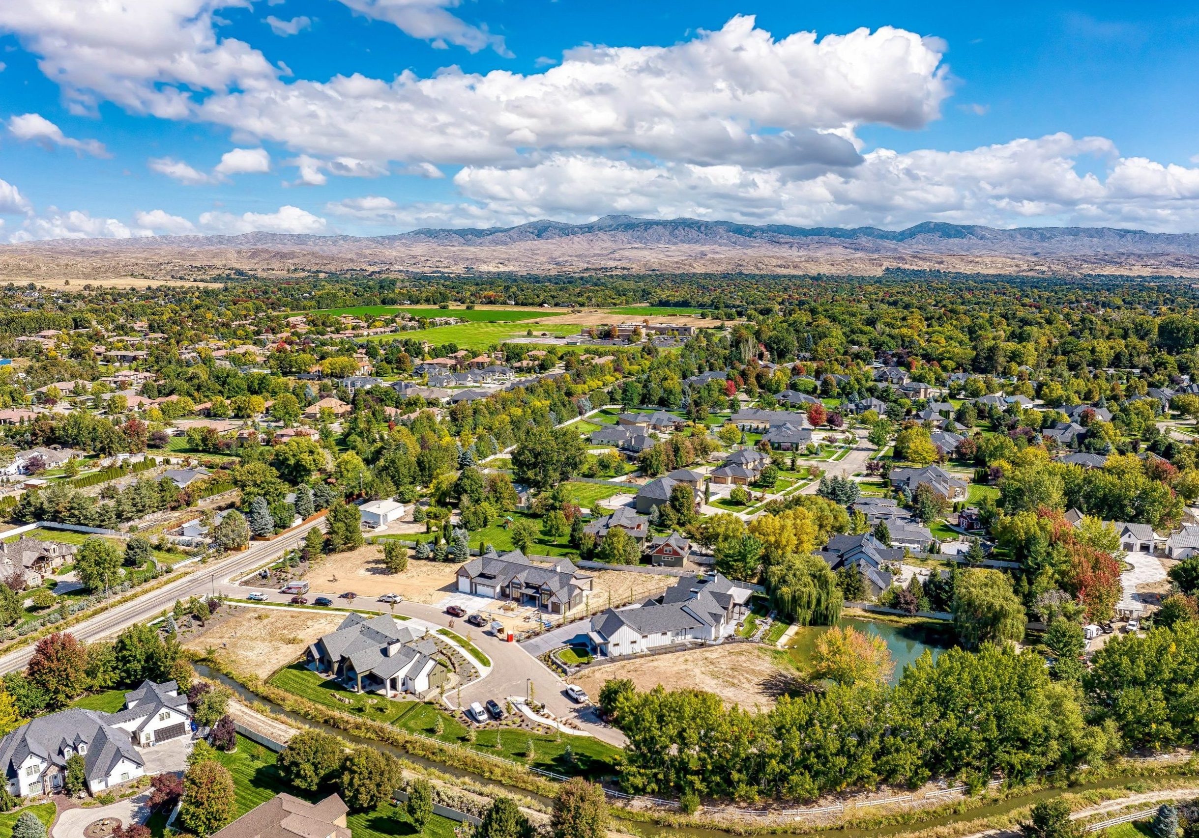 Aerial view of the Arrano Farms boutique community with bright blue sky and lush foliage and greenery surrounding